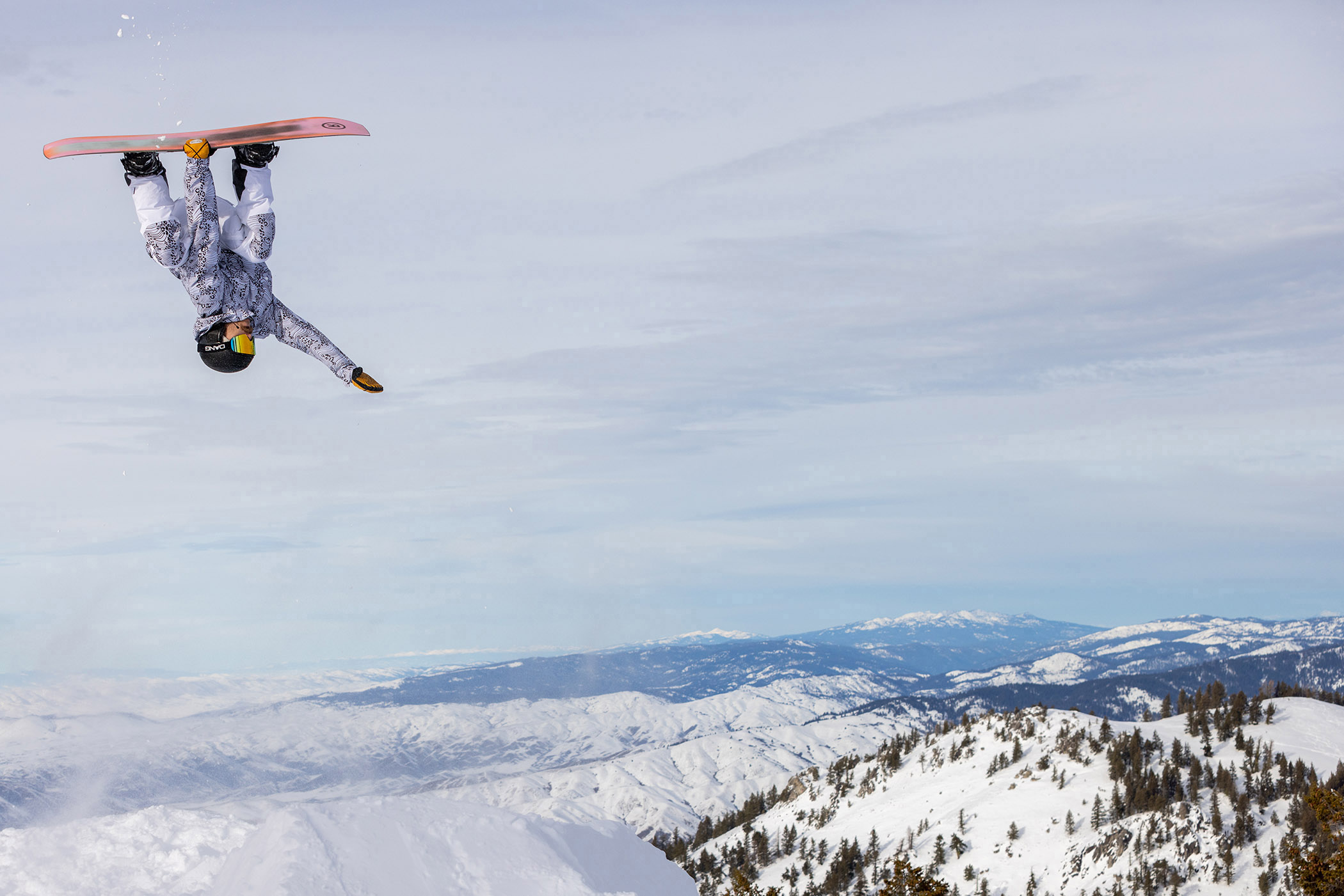 Austin Smith performs inverted aerial on snowboard at Bogus Basin. 