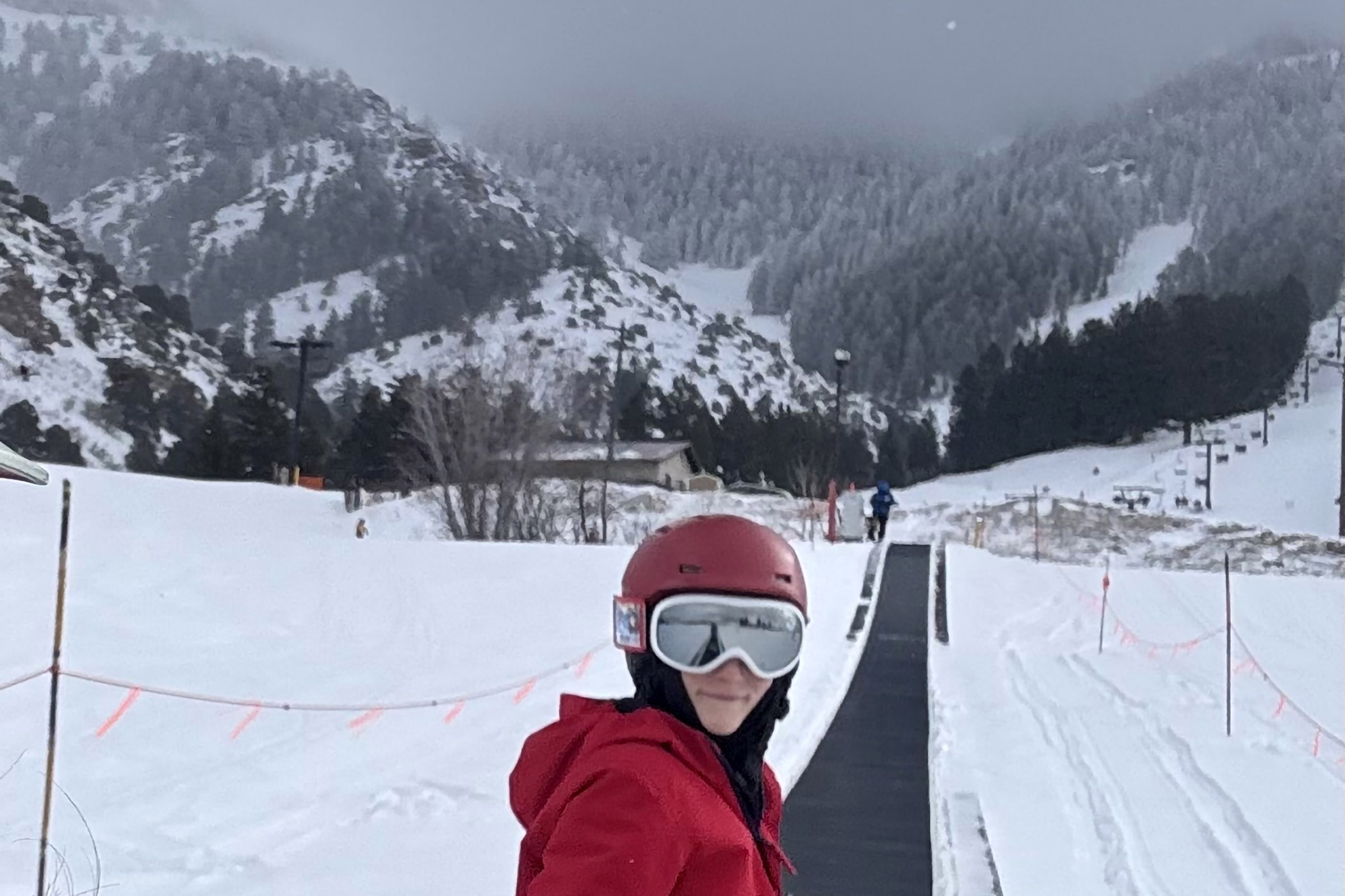 Young skier rides Pebble Creek Ski Area's magic carpet. 